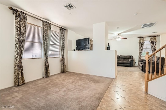 11276 Accademia Ct, Las Vegas, NV 89141 - spare room with a ceiling fan, light tile patterned floors, stairway, and light carpet