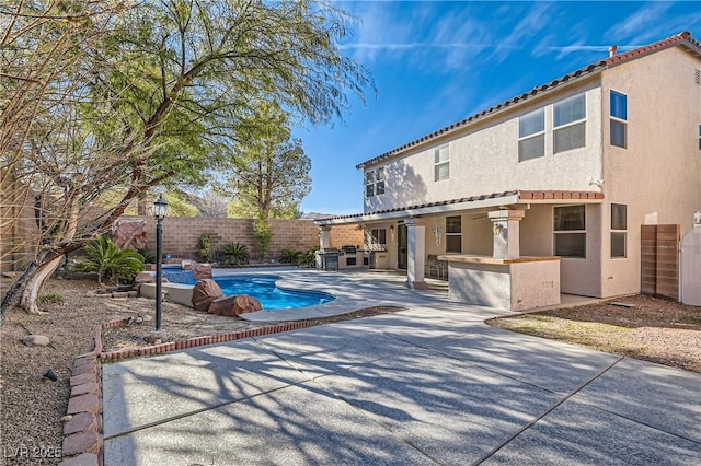 11276 Accademia Ct, Las Vegas, NV 89141 - view of swimming pool featuring a fenced backyard, a patio, and exterior kitchen