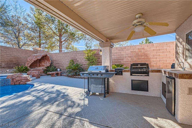 11276 Accademia Ct, Las Vegas, NV 89141 - view of patio featuring exterior kitchen, fence, ceiling fan, grilling area, and a sink