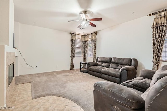 11276 Accademia Ct, Las Vegas, NV 89141 - living room with a ceiling fan, light carpet, plenty of natural light, and a tiled fireplace