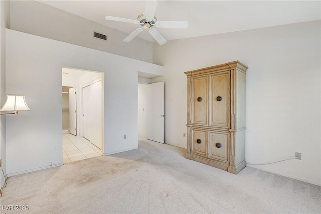 spare room featuring ceiling fan, high vaulted ceiling, and light colored carpet