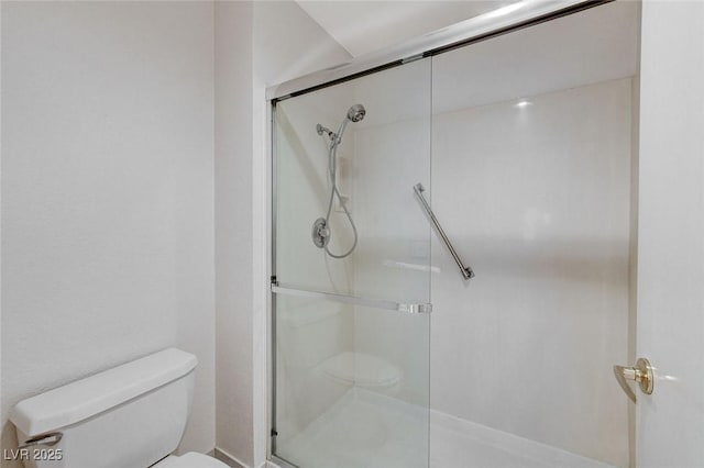 bathroom with toilet and walk in shower