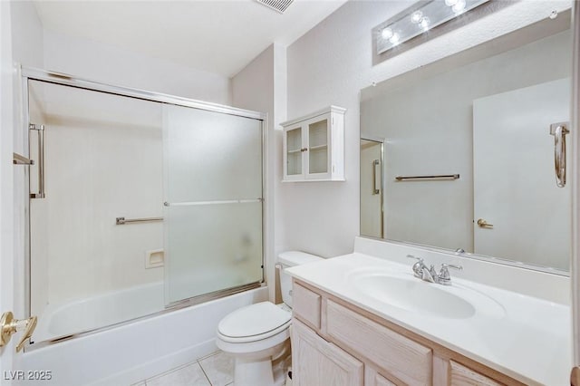 full bathroom with tile patterned flooring, vanity, enclosed tub / shower combo, and toilet