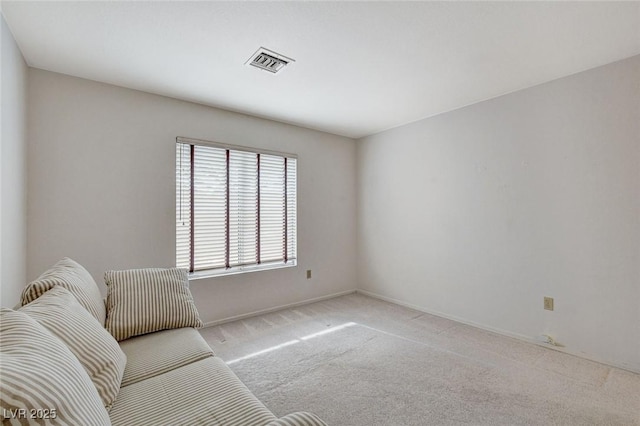 living area featuring light carpet