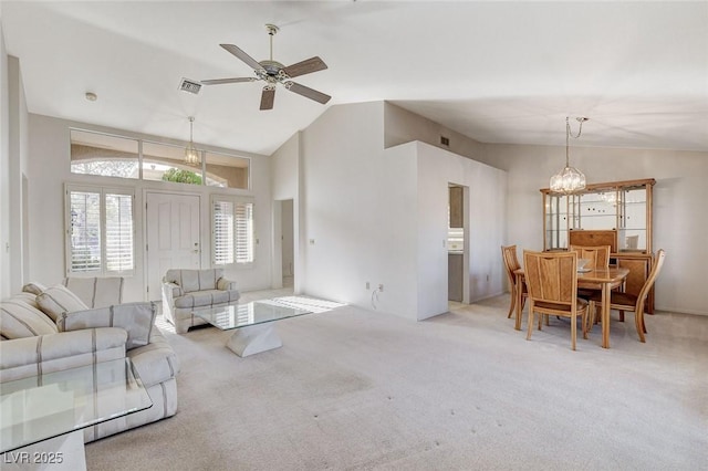 living room featuring ceiling fan, light colored carpet, and vaulted ceiling