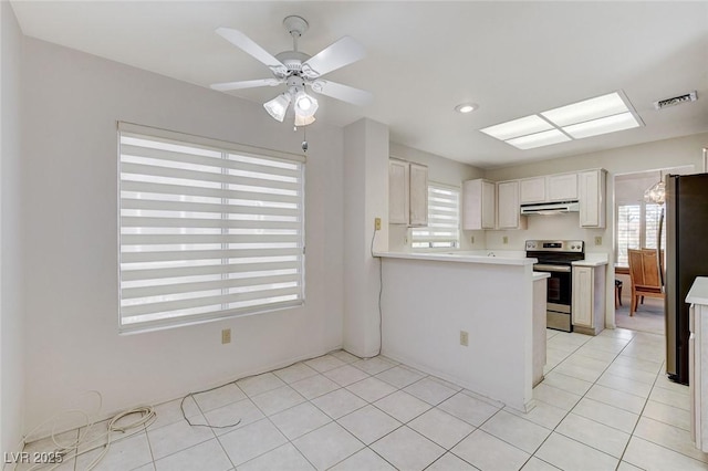 kitchen featuring white cabinets, ceiling fan, light tile patterned floors, and appliances with stainless steel finishes