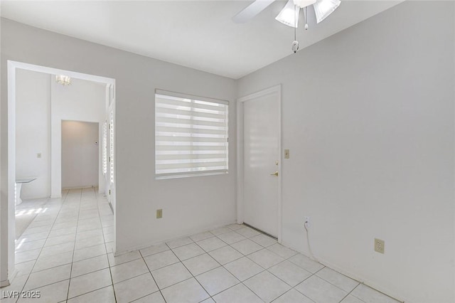 empty room featuring ceiling fan and light tile patterned flooring