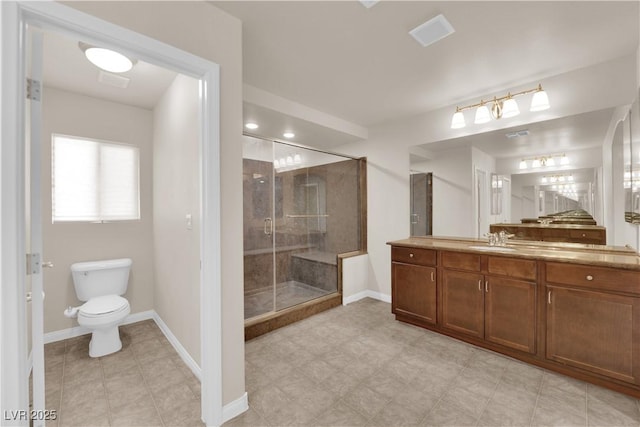 bathroom featuring an enclosed shower, vanity, and toilet