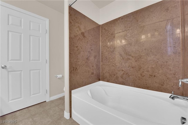 bathroom with tile patterned flooring and a bathtub