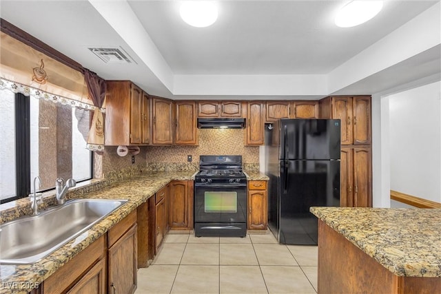 kitchen with black appliances, sink, tasteful backsplash, light tile patterned flooring, and light stone counters