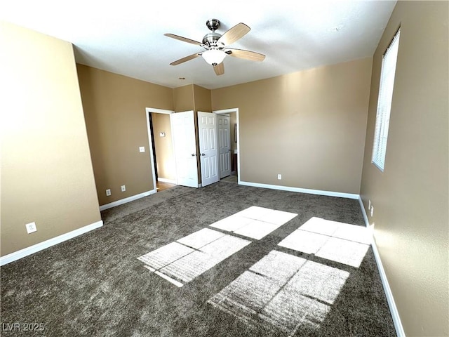 unfurnished bedroom featuring dark carpet and ceiling fan