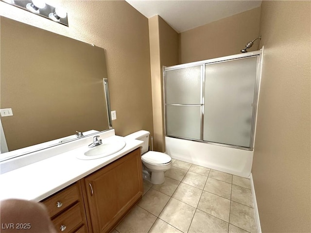 full bathroom featuring toilet, shower / bath combination with glass door, tile patterned floors, and vanity