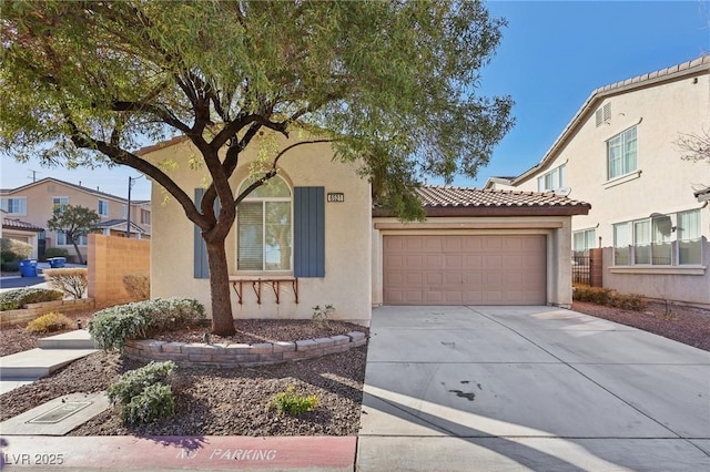 mediterranean / spanish-style house with a garage