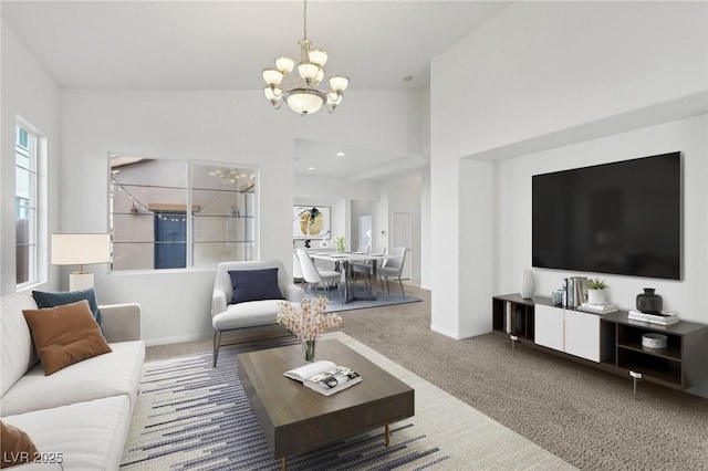 living room with vaulted ceiling, carpet flooring, and an inviting chandelier