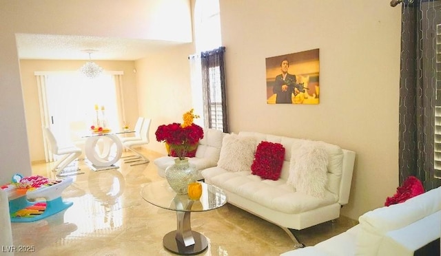 living room with a chandelier and a textured ceiling