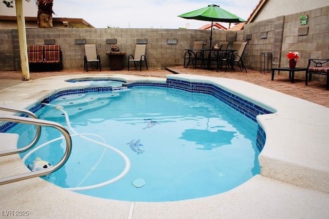 view of pool featuring an in ground hot tub and a patio