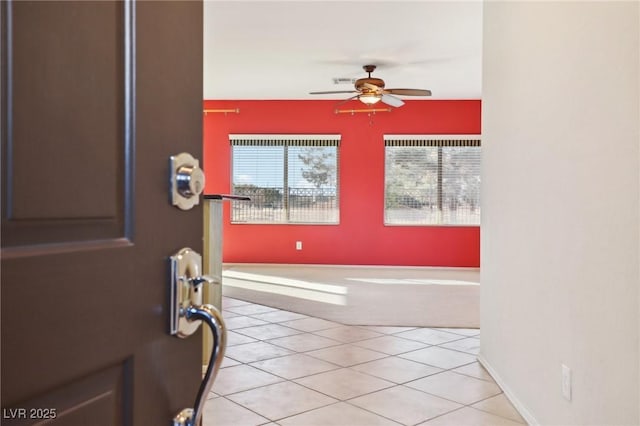 entryway with ceiling fan and light tile patterned floors