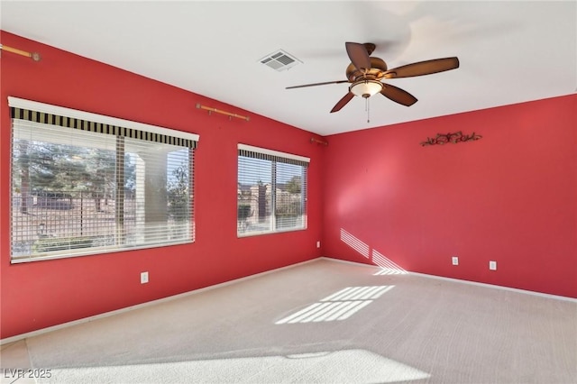 unfurnished room featuring ceiling fan and carpet floors