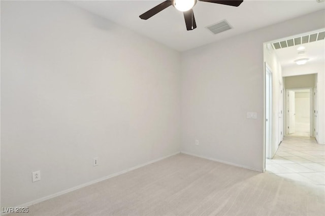 carpeted spare room with ceiling fan