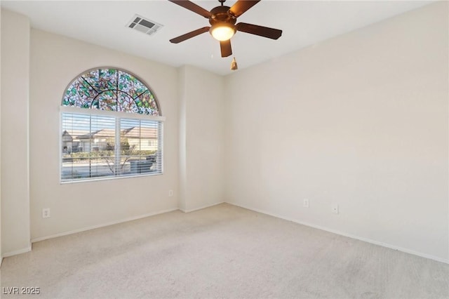 carpeted spare room with ceiling fan