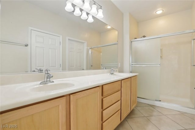 bathroom with tile patterned floors, vanity, and an enclosed shower