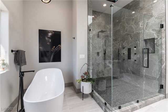 full bathroom featuring marble finish floor, baseboards, a freestanding bath, and a marble finish shower