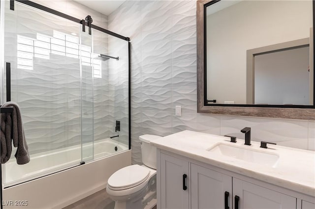 full bathroom with decorative backsplash, toilet, enclosed tub / shower combo, vanity, and tile walls