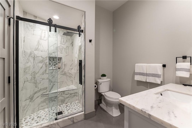 full bath with toilet, a marble finish shower, and vanity