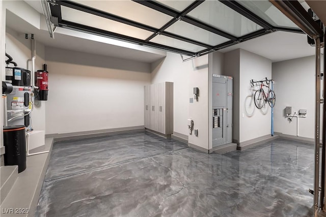 garage featuring heat pump water heater and baseboards
