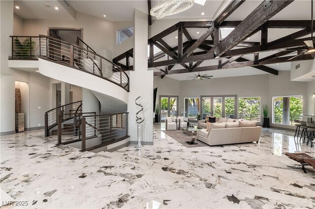 living room featuring a high ceiling and a chandelier