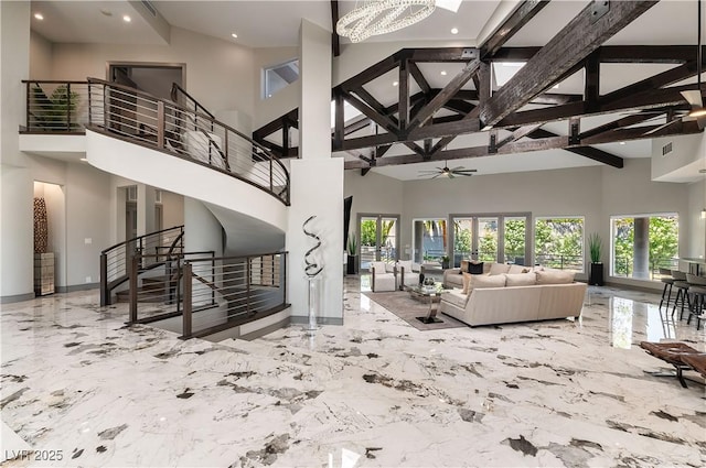 living area with a ceiling fan, marble finish floor, stairs, high vaulted ceiling, and beamed ceiling