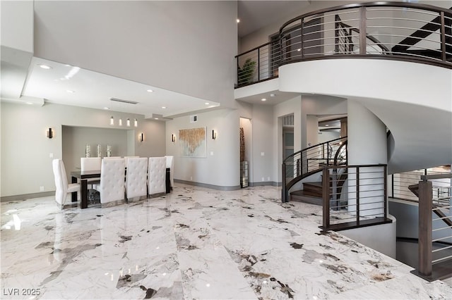 entryway featuring baseboards, marble finish floor, a high ceiling, stairs, and recessed lighting