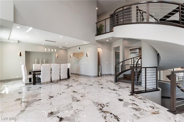 entrance foyer with stairs, marble finish floor, a towering ceiling, recessed lighting, and baseboards