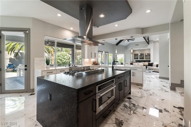 kitchen with white cabinetry, island exhaust hood, stainless steel gas cooktop, and recessed lighting