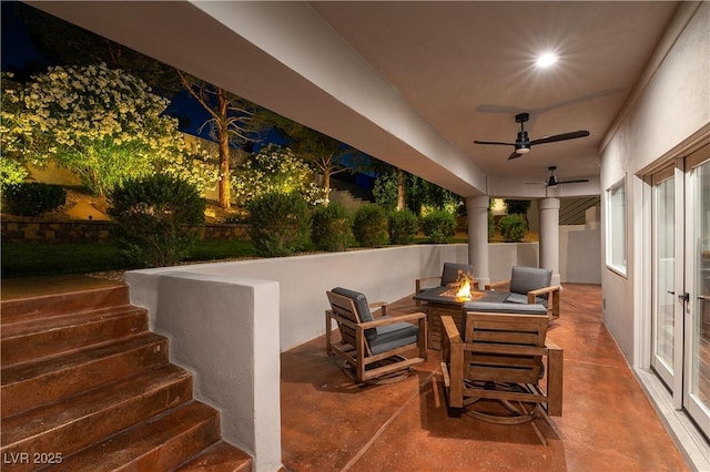 view of patio featuring an outdoor fire pit and ceiling fan