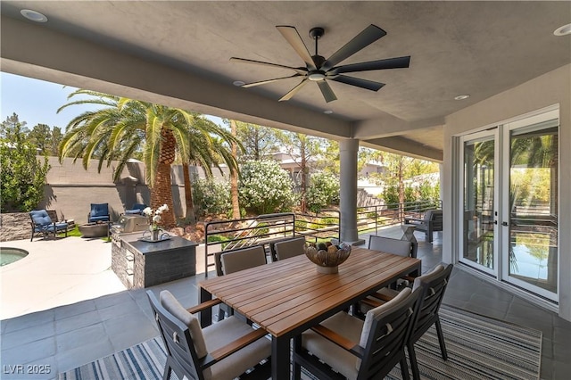 view of patio / terrace featuring french doors, outdoor dining space, fence, and a ceiling fan