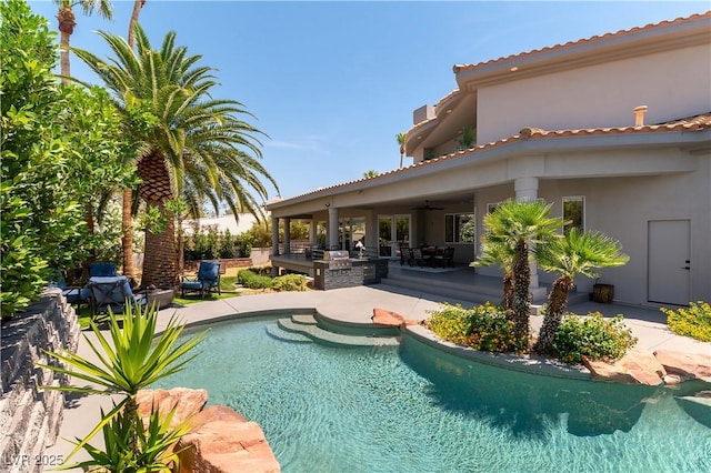 view of swimming pool with a patio, a fenced in pool, and a ceiling fan