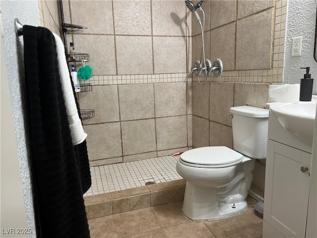 307 E Van Wagenen St, Henderson, NV 89015 - bathroom featuring a tile shower, vanity, tile walls, tile patterned flooring, and toilet