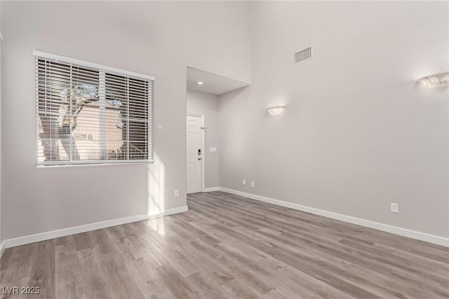 unfurnished room with hardwood / wood-style floors