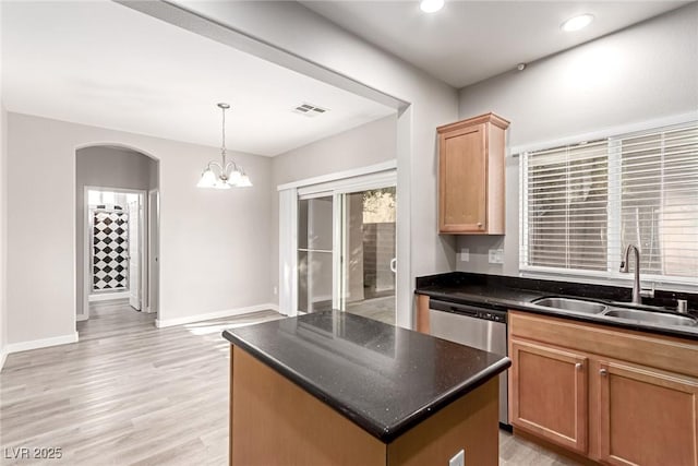 kitchen featuring dishwasher, sink, a center island, hanging light fixtures, and an inviting chandelier