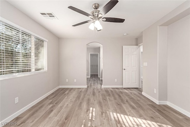 unfurnished room with ceiling fan and light wood-type flooring