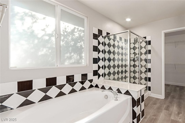 bathroom featuring hardwood / wood-style flooring, plenty of natural light, and shower with separate bathtub