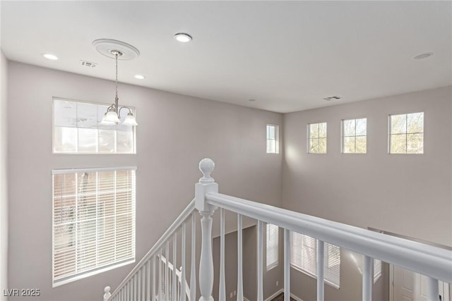 hallway with a chandelier