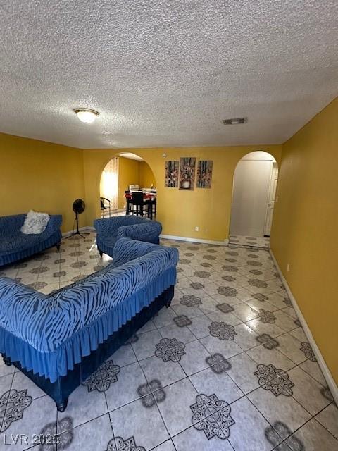 tiled living room with a textured ceiling