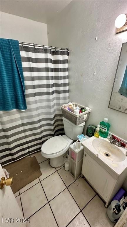 bathroom featuring vanity, curtained shower, tile patterned floors, and toilet