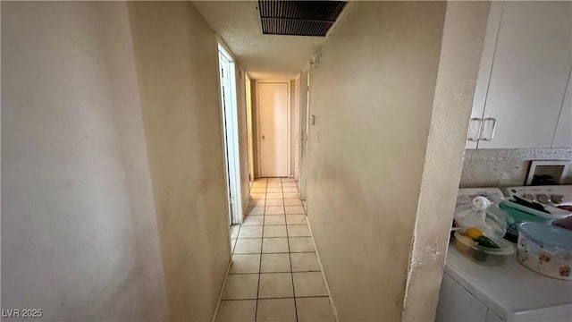 hallway with light tile patterned floors