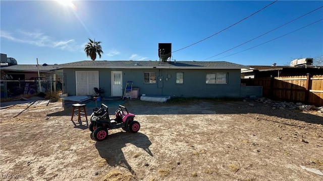 rear view of property featuring central AC