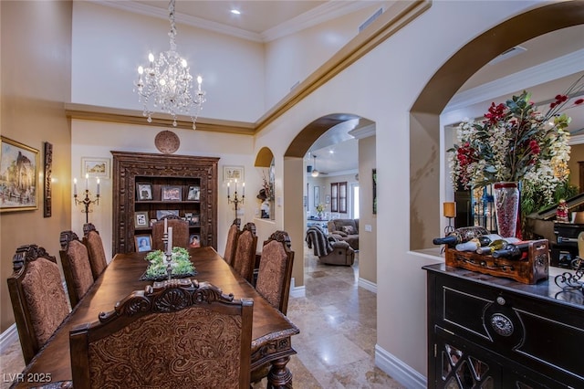 dining area featuring crown molding and a chandelier