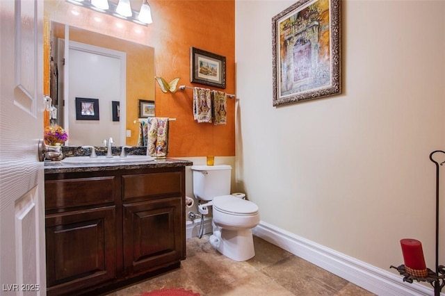 bathroom featuring toilet and vanity