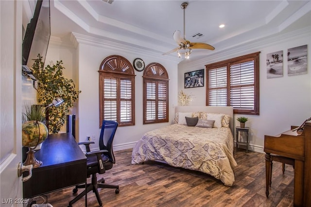 bedroom with ceiling fan, crown molding, dark hardwood / wood-style flooring, and a raised ceiling